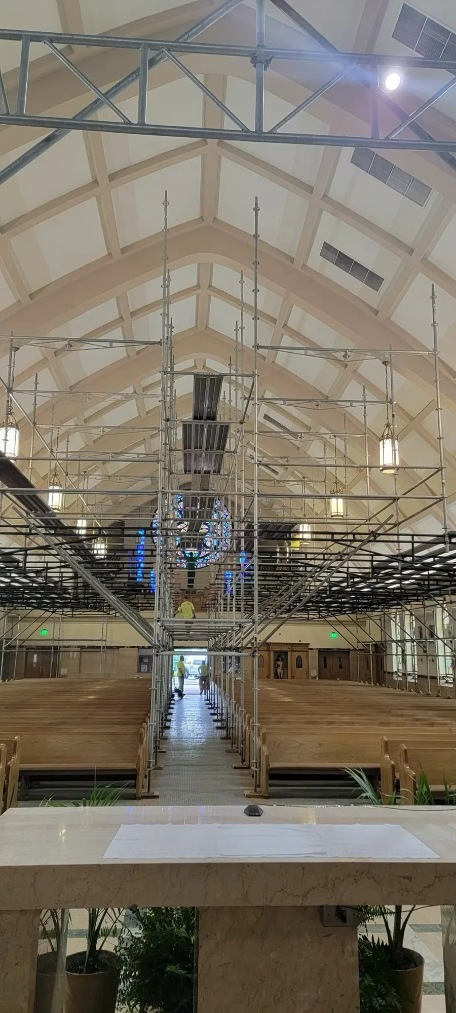 Interior framing and drywall running up a cathedral ceiling on an active job site